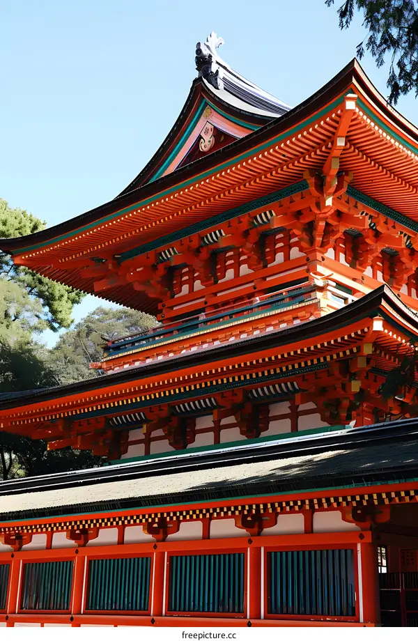 A photo of a traditional Chinese courtyard with red walls and green roof tiles.
