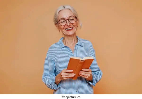 Senior Woman Reading a Book in a Light Blue Shirt