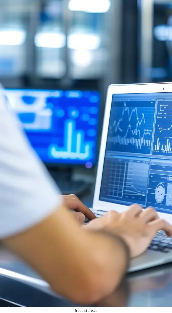 A researcher is working on a laptop in a laboratory.