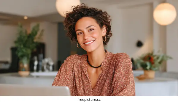 Smiling Woman Working on Laptop in Cozy Cafe