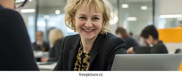 Smiling Woman Working at Computer in Office