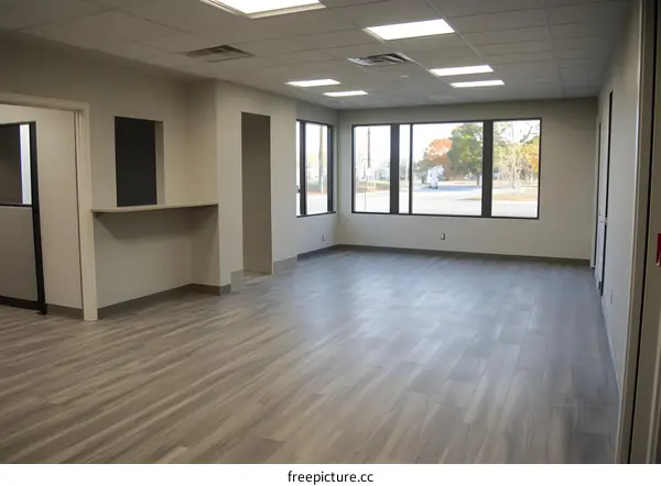 Empty Office Space With Laminate Flooring and Windows