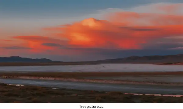 Vibrant Orange Sunset Over A Vast Open Landscape