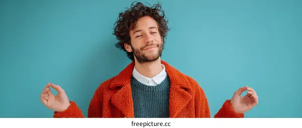 Relaxing Man in Cozy Orange Coat Against Teal Background