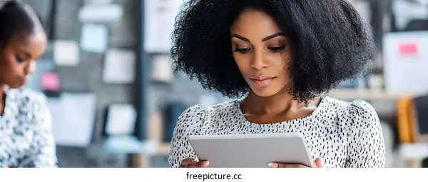 African American Woman Working on a Tablet in an Office