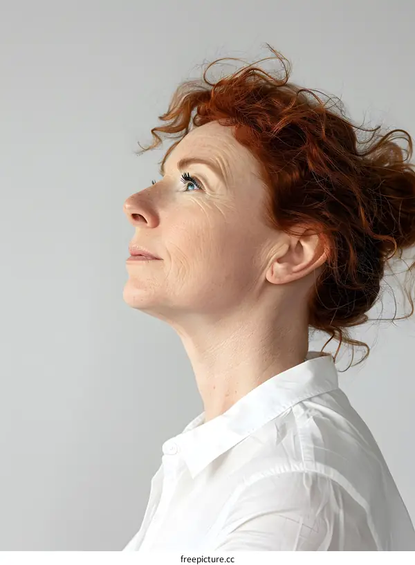 Woman with red hair looking up