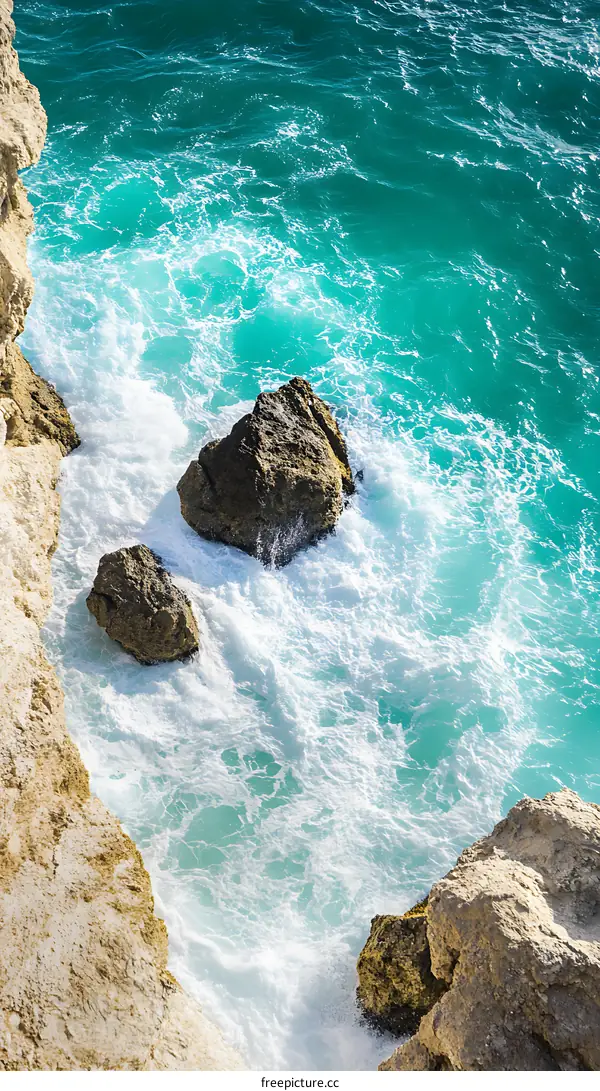 Aerial View of Waves Crashing on Rocks