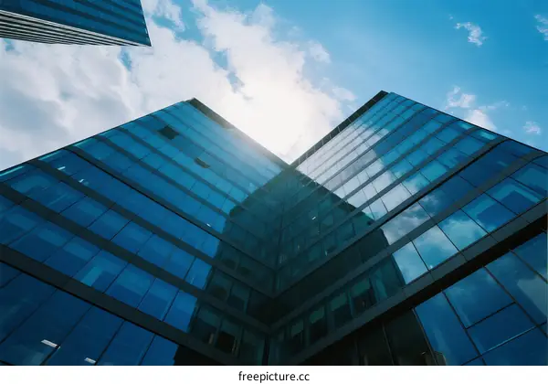 Modern glass skyscrapers under a bright blue sky