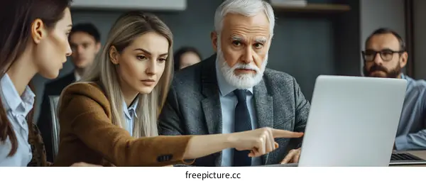 Business Team Meeting Discussing Project On Laptop