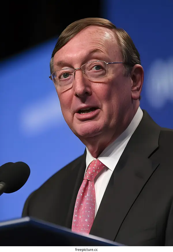 Man in a Suit Speaking at a Press Conference