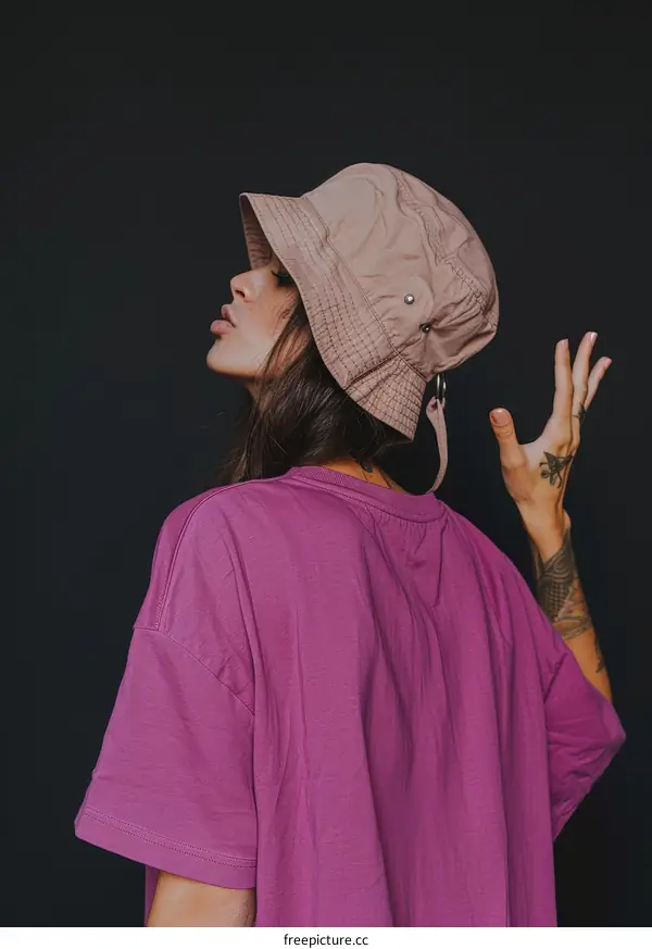 Portrait of a young woman wearing a bucket hat and a pink t-shirt