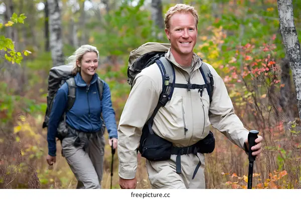 Couple Hiking Through Autumn Woods