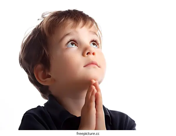 Young Boy Praying with Hands Together Looking Up