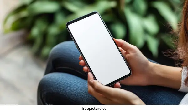 Woman holding a smartphone outdoors