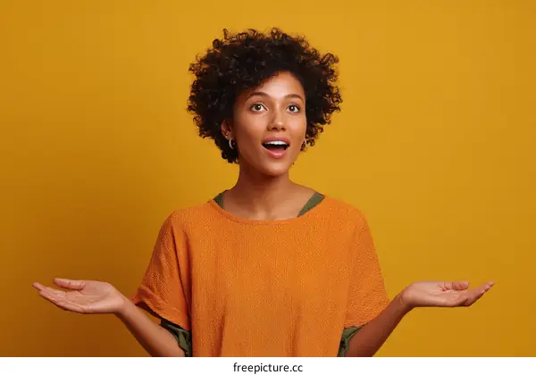 Surprised Young African American Woman with Curly Hair Gesturing