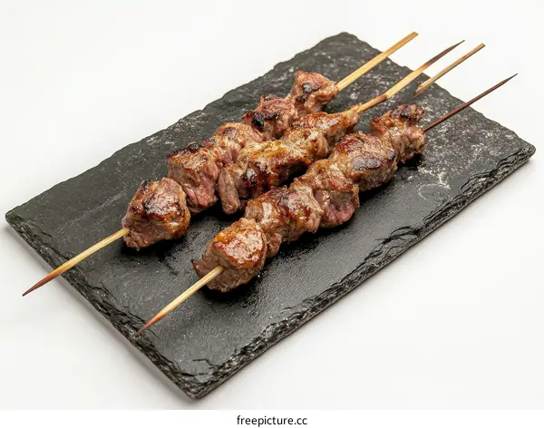 Delicious Grilled Meat Skewers on a Slate Plate
