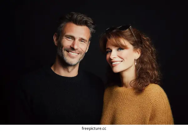 Smiling Couple Portrait Against Black Background