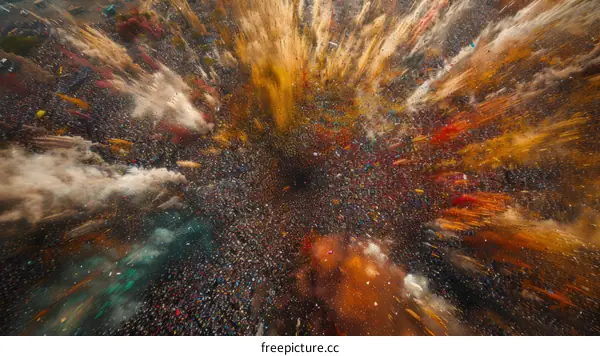 A large crowd of people throwing colorful powder into the air