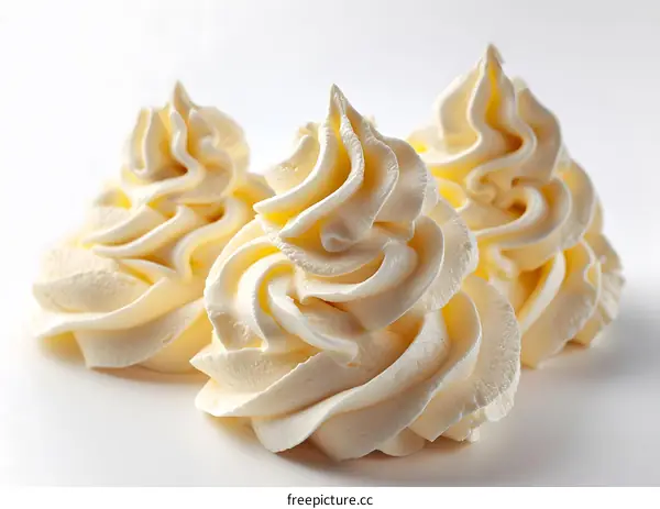 Three Swirls of Whipped Cream on White Background