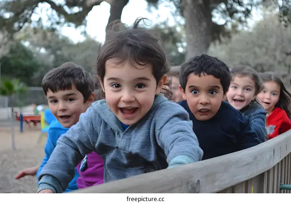 Happy Children Play on Wooden Fence