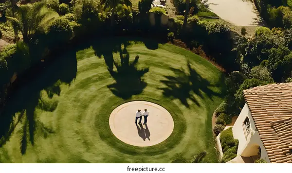 Aerial View of Two Men Standing on a Circle in a Garden