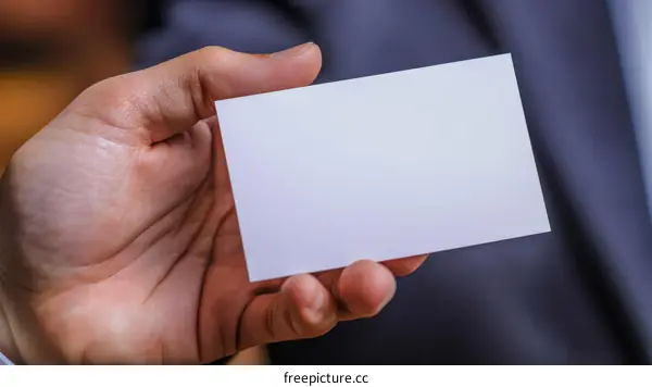 Business Card in Hand Showing Professionalism