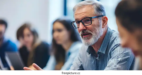 Senior Man Talking in Classroom with Students
