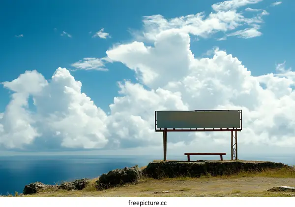 Empty Billboard and Bench on Cliff Overlooking Ocean
