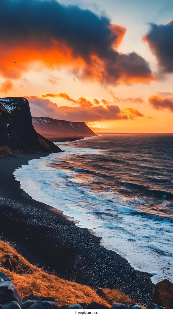 Black Sand Beach And Dramatic Sunset Sky