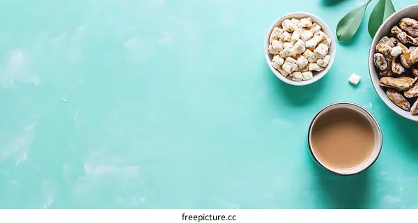 Top View of Coffee with Sugar Cubes and Snacks on Blue Background