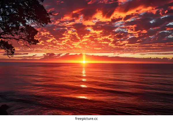 red sunset over calm sea with dark clouds