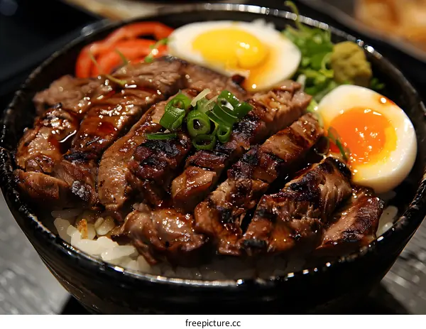 A delicious bowl of gyudon with rice, beef, and egg