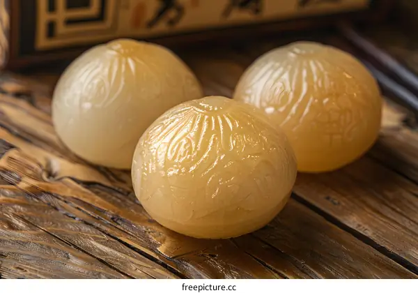 Closeup of Three Carved Chinese Jade Spheres on Wooden Table