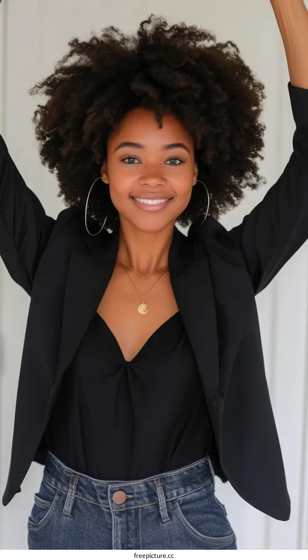 Portrait of a young woman with curly hair smiling
