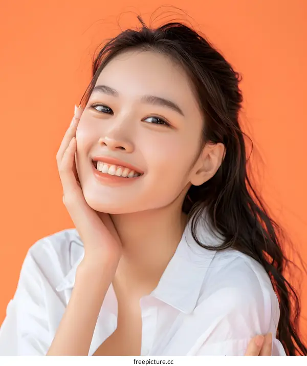 Portrait of a Smiling Asian Woman with Long Hair Wearing a White Shirt