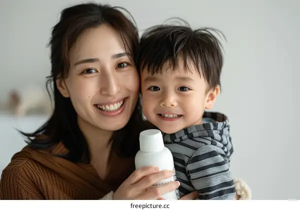 A mother and her son are smiling at the camera.