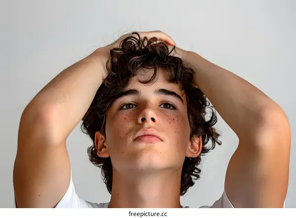 Portrait of a young male with freckles and curly hair