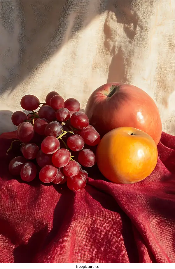 Still Life Photography of Grapes Apple and Pear on Red Cloth