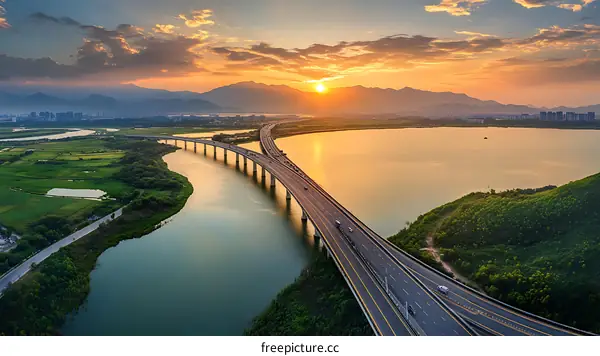 Aerial View of Highway Crossing River at Sunset