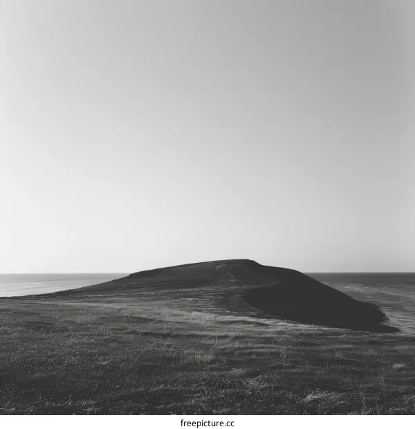 Hill on the Horizon Over the Ocean in Black and White