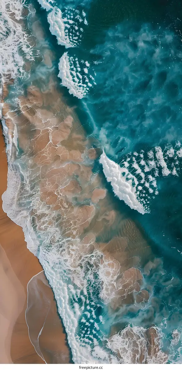 Aerial View of Turquoise Ocean Waves Crashing on Sandy Beach