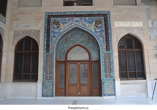 Intricate Mosaic Tiles Decorate an Arched Doorway of a Building