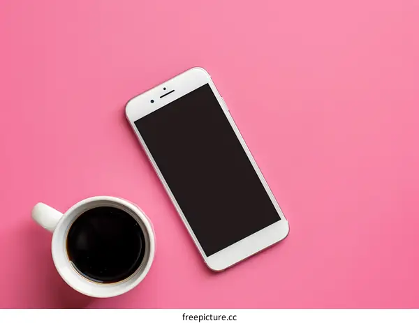 White Smartphone and Cup of Coffee on Pink Background