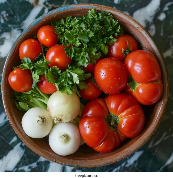A bowl of fresh organic vegetables including tomatoes, onions and parsley