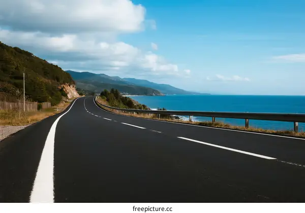 Scenic coastal road with clear blue sky and ocean view