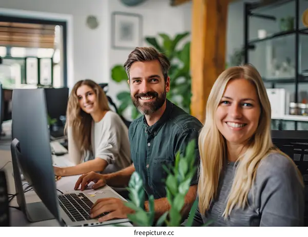 portrait of three young business people smiling at the camera