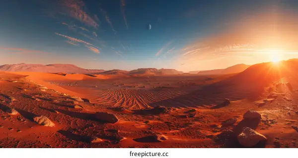 Red sand desert with blue sky and sun