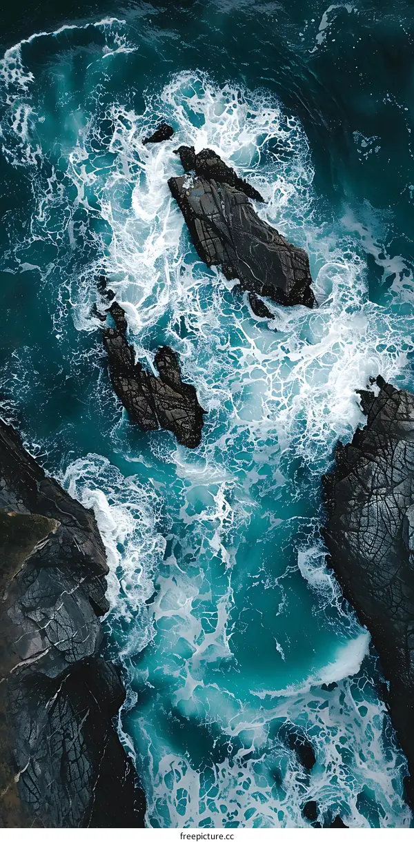 Aerial View of Ocean Waves Crashing on Rocks
