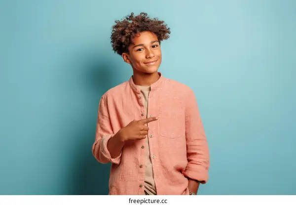 Smiling Black Teenager in a Light Pink Shirt