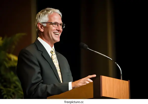 Smiling Speaker Giving Speech at Podium